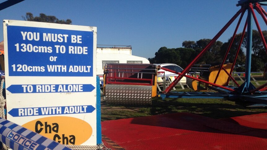A carnival sign says 'you must be 130m to ride' and stands in front of the Cha Cha ride at Rye.
