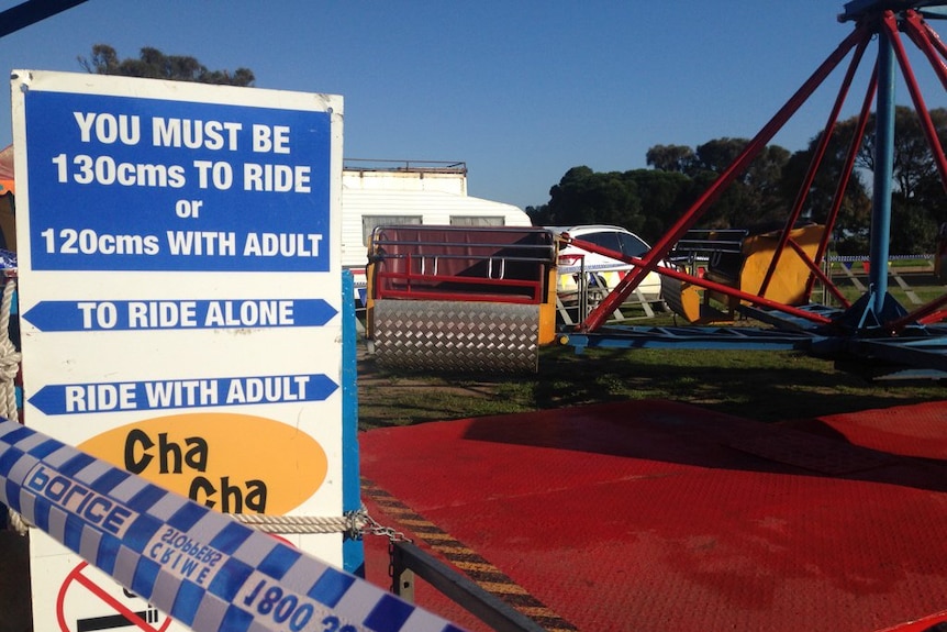 A carnival sign says 'you must be 130m to ride' and stands in front of the Cha Cha ride at Rye.