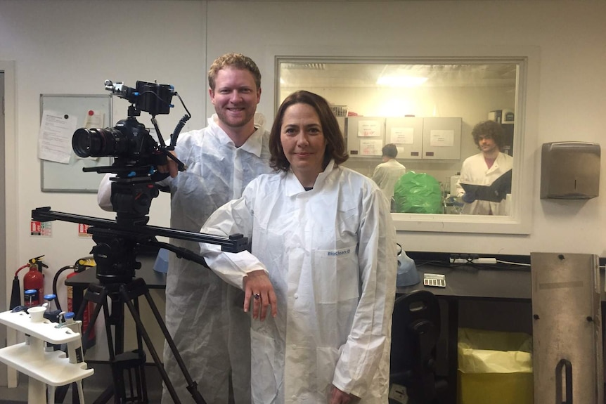 Cameraman Cameron Bauer and Lisa Millar in a laboratory.