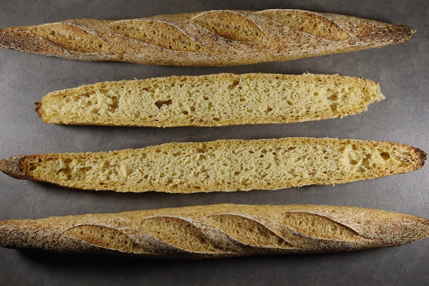 Two cut open baguettes on display, showing both outer crust and inside texture