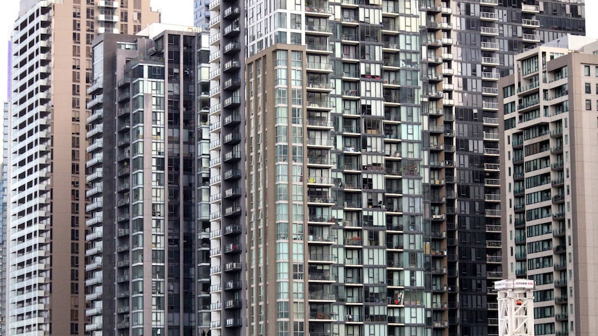 Towers dotted with windows and balconies rise into the sky.