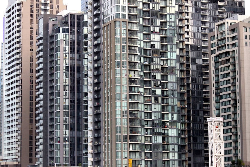 Towers dotted with windows and balconies rise into the sky.