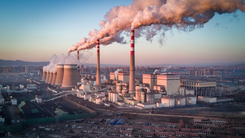 A shot of an active coal-fired power station near a residential area in China.