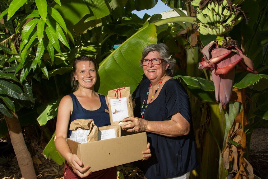 Jenna Cowie and Trish Pepper with their repackaged coffee ground fertiliser.