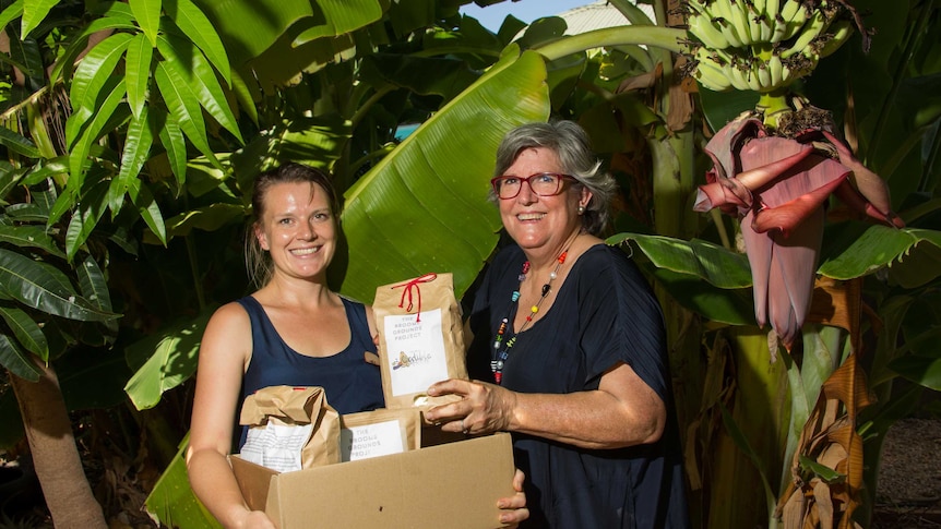 Jenna Cowie and Trish Pepper with their repackaged coffee ground fertiliser.