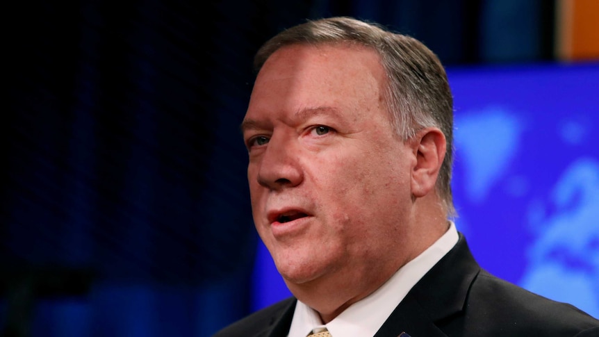 A close up of Mike Pompeo talking in front of a blue screen.