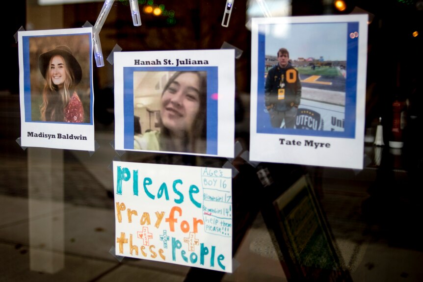 Photos of three of the four teens killed in the Oxford High School shooting are posted on the window.