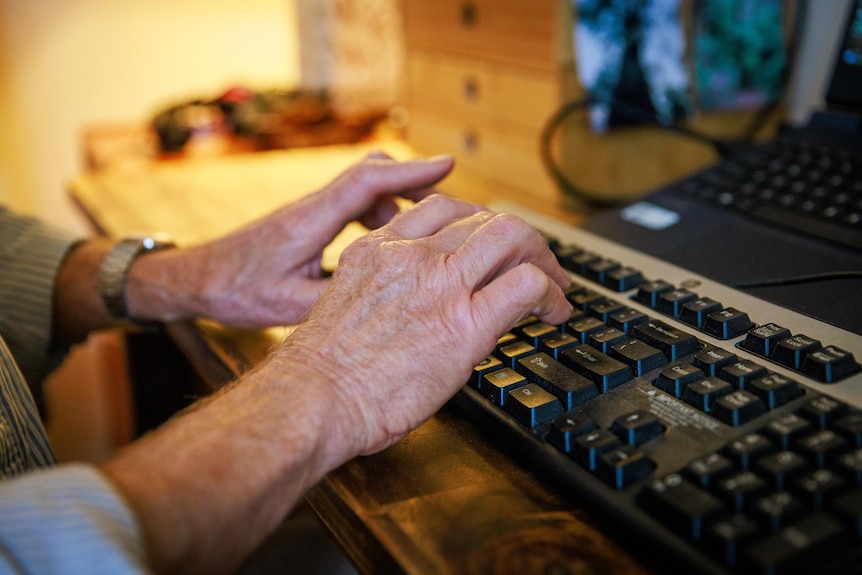 Close up image of hands typing on a keyboard