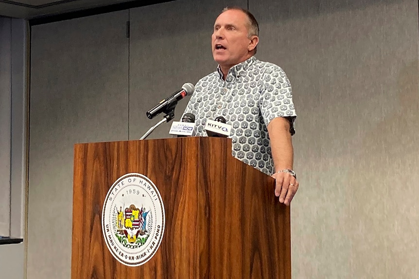 A man standing at a lectern 