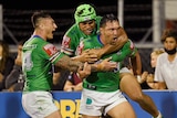 A group of NRL players celebrate a try 