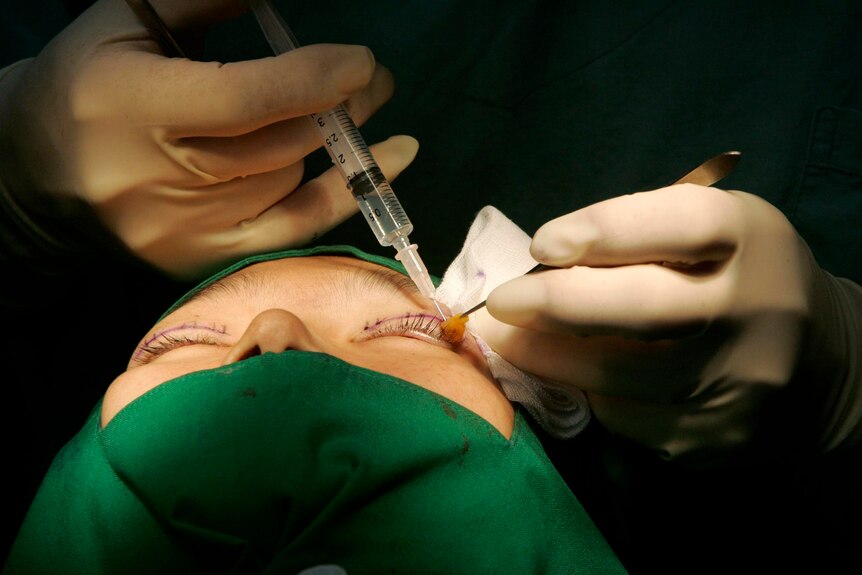 Close up of someone having a cosmetic injection near their left eye