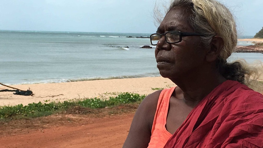 Indigenous woman standing on a beach in the Northern Territory.