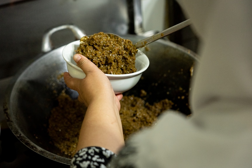 A spicy paste is served in a bowl.