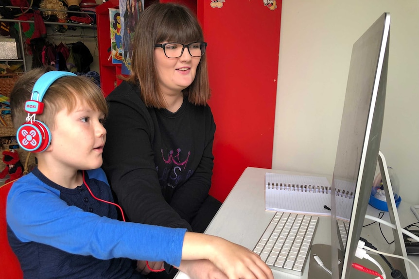 Daisy and her eight-year-old brother Fletcher do a lesson at his computer.