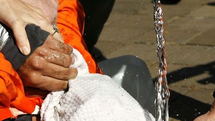 A demonstrator is held down during a simulation of waterboarding in Washington in 2007.