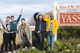 The 'Fab Five' from Queer Eye for the Straight Guy posing with the Yass sign.