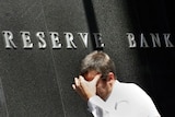Man walks past the Reserve Bank building in Sydney