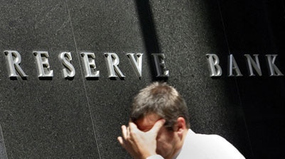 Man walks past the Reserve Bank building in Sydney