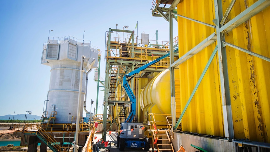 large industrial buildings with pipes and ladders