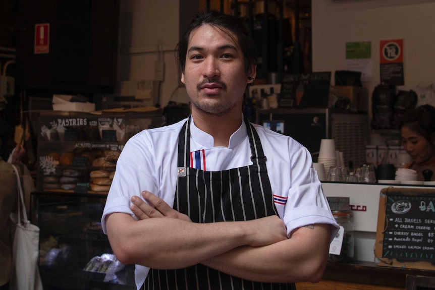 Close up shot of a man in apron with arms crossed