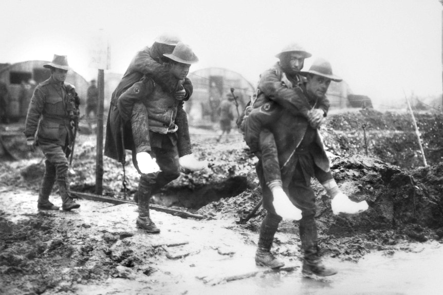 Ambulance men carry their comrades who are suffering from trench feet at the Somme.
