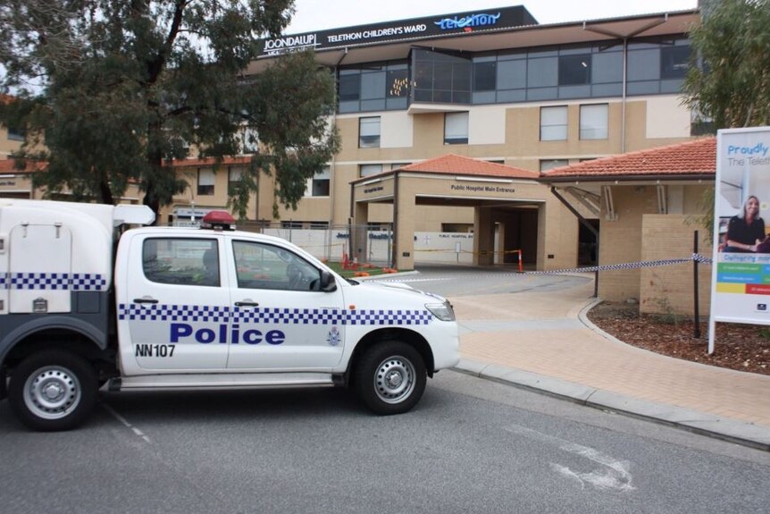 A police car and police tape is around the entrance to Joondalup hospital where a woman died after being dumped from a car.