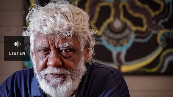 Image of Elder William Tilmouth, gry hair and beard looking at the camera with art in the background. Has Audio.