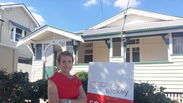 Real estate agent Gabrielle Trickey outside a three-bedroom Paddington home, which has seen a $70 a week reduction in rent.