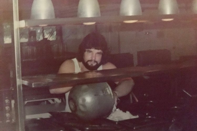 Man stands in kitchen in old photograph