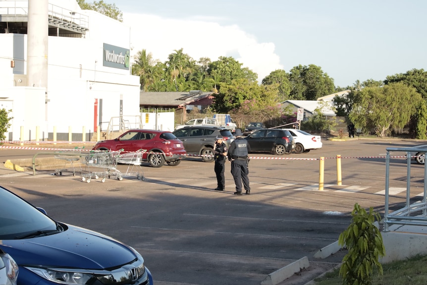 Two police officers standing in the middle of the Darwin shopping centre carpark