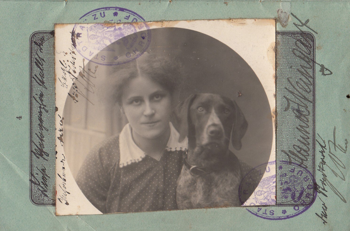 A black and white photo of a young woman pictured next to her dog for a passport photo. 