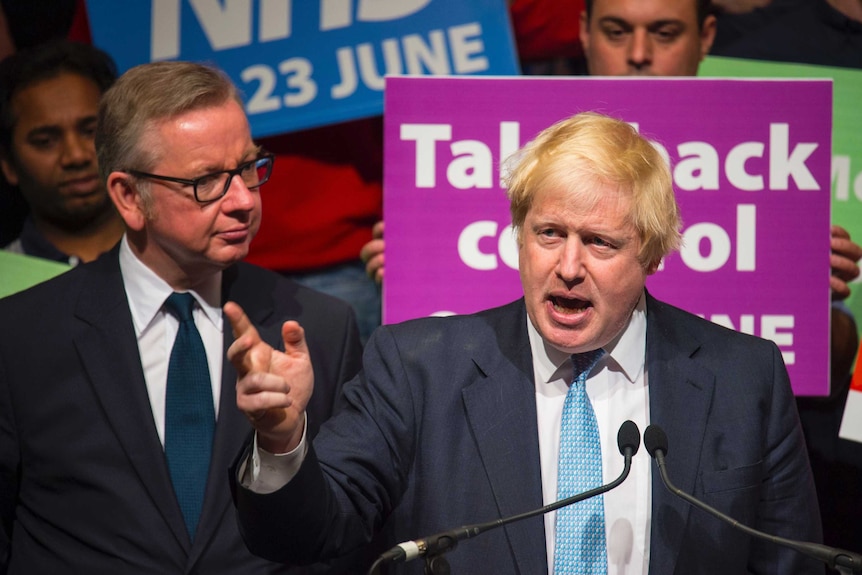 Boris Johnson speaks as Michael Gove listens