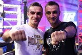 Jason Moloney and Andrew Moloney pose by holding their fists forward standing next to each other
