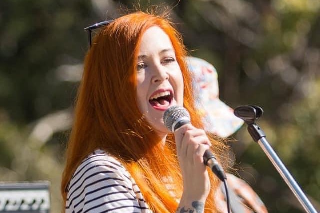 Georgiana Mannion singing into a microphone