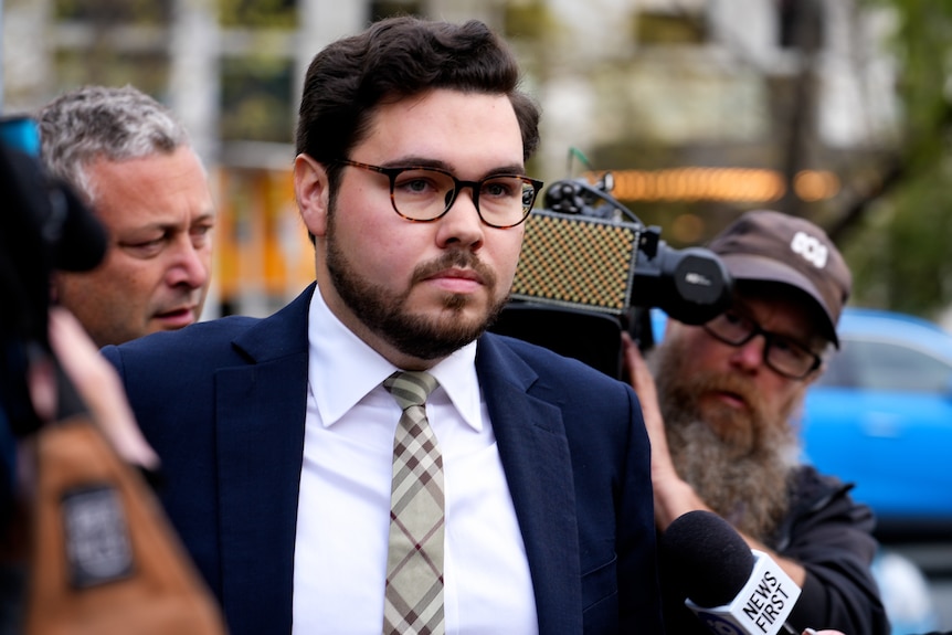 A man surrounded by cameras. 