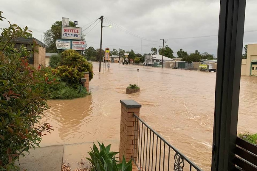 Brown water covering the roads and entering front of Olympic Motel.