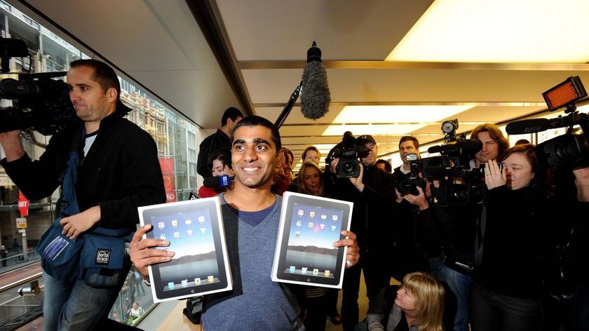 Rahul Koduri holds up his newly purchased iPads