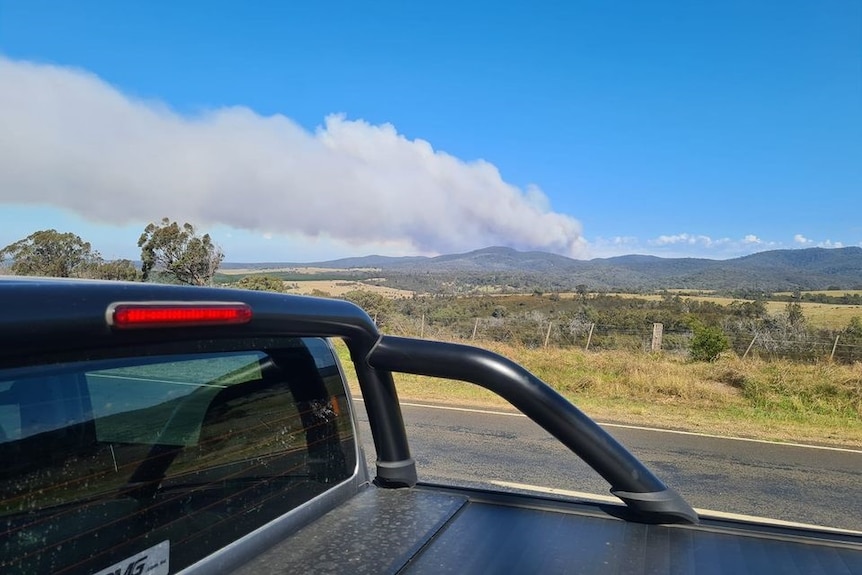 Smoke from a bushfire taken from the back of a ute.