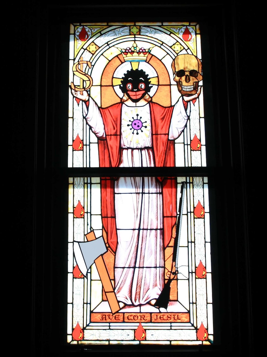 Detail from a leadlight window featuring a golliwog figure as a saint holding a dollar sign and a skull.