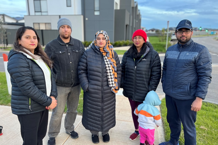 Mt Atkinson residents look stern standing in a housing estate.