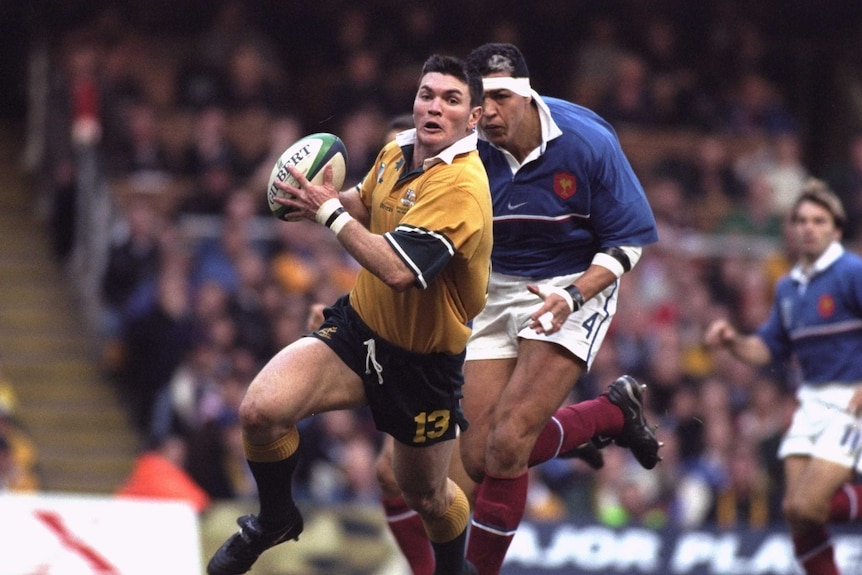 Attacking threat ... Daniel Herbert takes on the French defence in the 1999 Rugby World Cup final