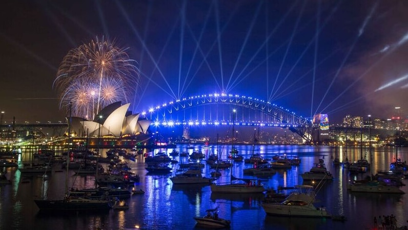 Sydney Harbour awash in blue on New Year's Eve.