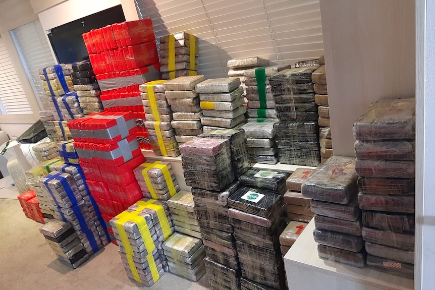 Brightly coloured packages stacked up in a room.