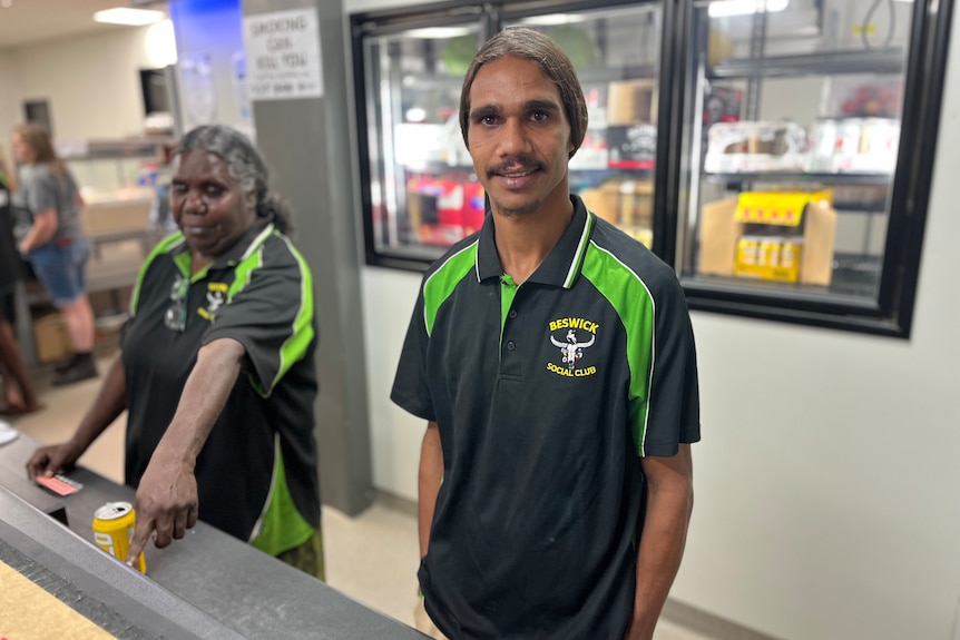 a young aboriginal man working behind a bar