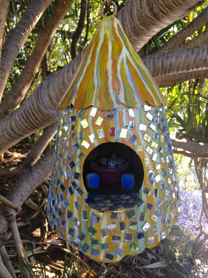 Mirrored fairy house hanging in tree