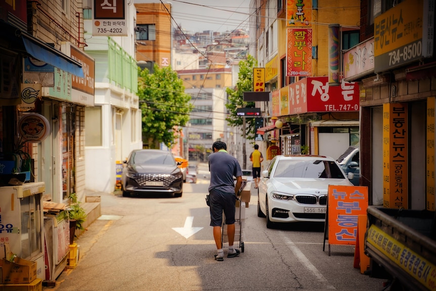 A man pushes a trolley.