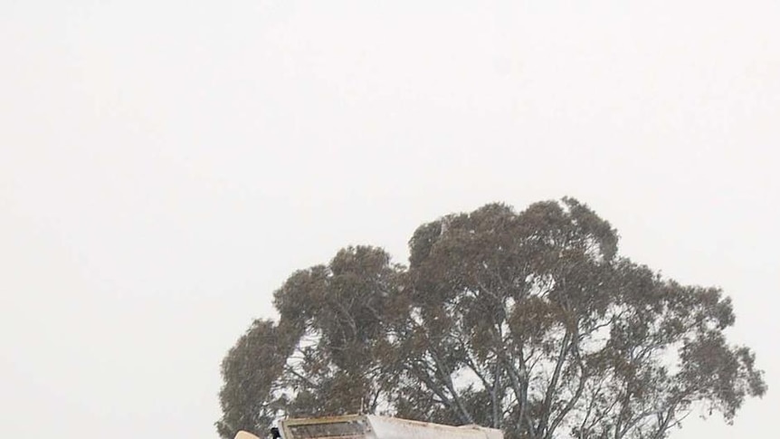 Snow blankets a tractor in Laggan, near Crookwell in the New South Wales southern tablelands.