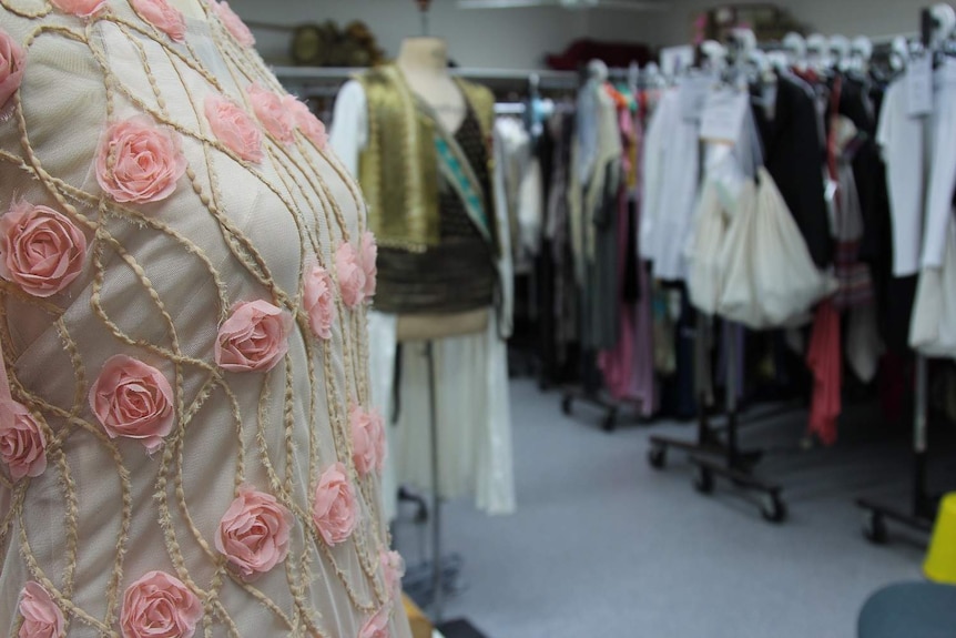 Close up of dress with hand stitching and pink roses