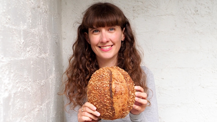 Mary Grace Quigley holding a loaf of bread