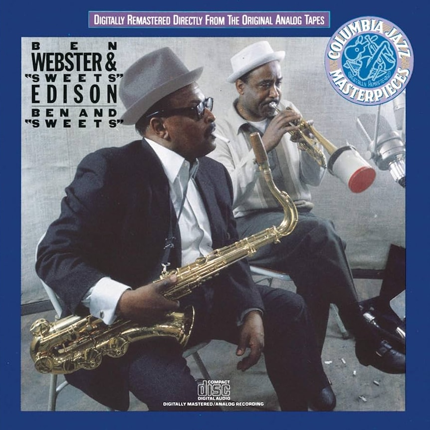A colour photo of Ben Webster and Harry Edison in the studio with their horns